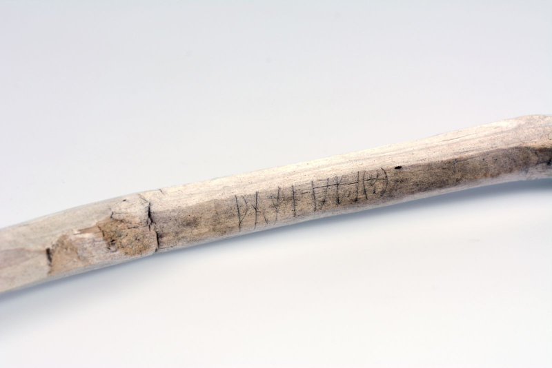 Close-up of a walking stick with a runic inscription, radiocarbon-dated to the 11th century AD. Found in a glaciated mountain pass. Photo: Vegard Vike, Museum of Cultural History.